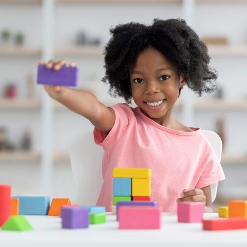 cute-little-black-girl-showing-purple-wooden-block-scaled-1-q173cnxmcoa1ln8v1pfbz5q0drj9rb6571wuk4zhqg